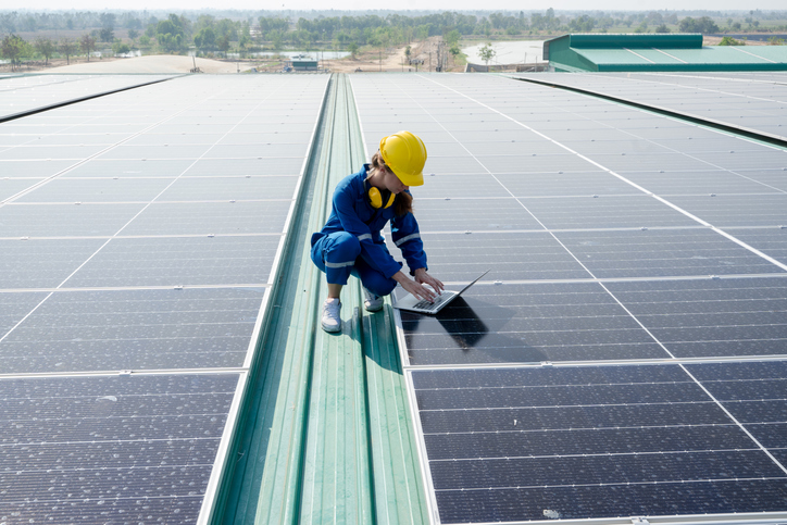 woman assessing solar panels image